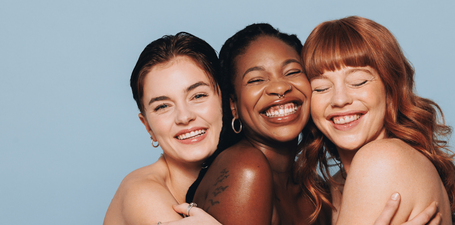 group of women smiling and hugging