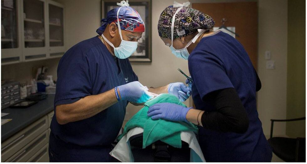 VA Derm Assoc performing a procedure