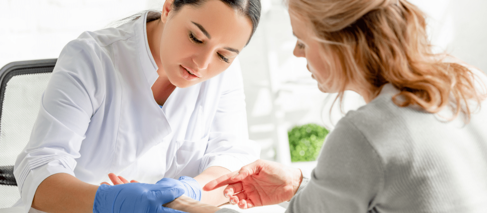 dermatologist examining a patient