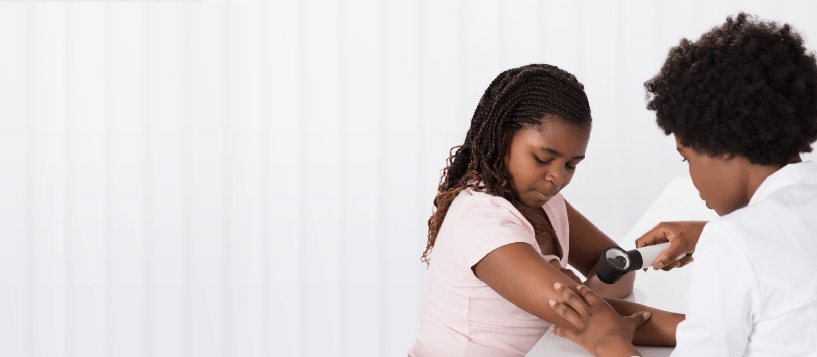 young girl with a dermatologist